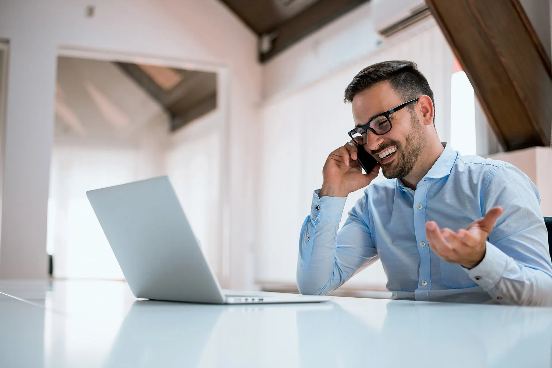 Businessman using computer and phone